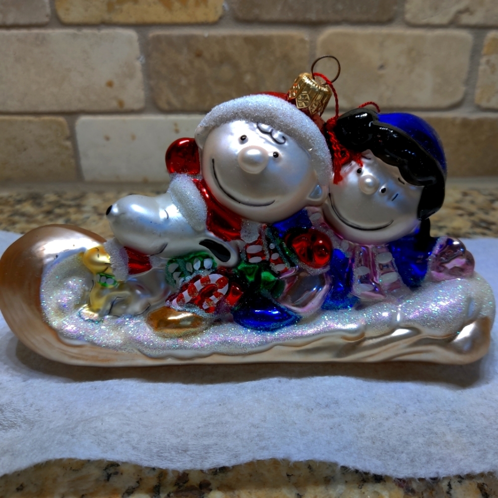 Vintage rare Kurt Adler Polonaise Peanuts On Toboggan Christmas ornament.